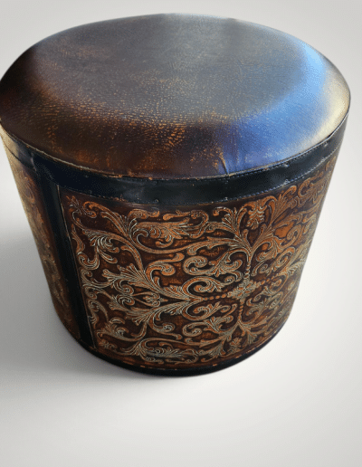 CBK Round Tooled Leather-Look Drum Ottoman with Embossed Scrollwork