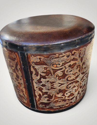 CBK Round Tooled Leather-Look Drum Ottoman with Embossed Scrollwork